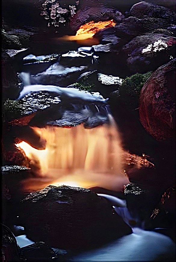 The waterfall feeding the Santa Cruz koi pond, lit at night