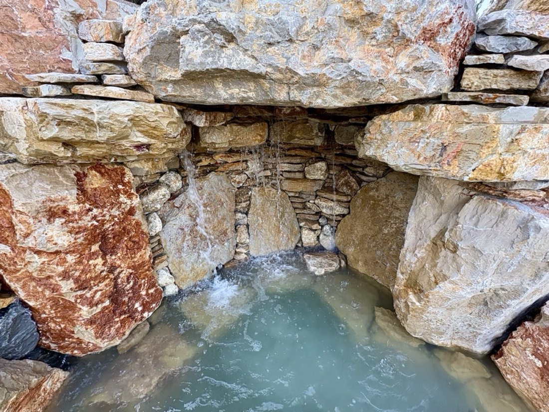 Stone cave and waterfall at the Lisbon Natural Pool Oasis