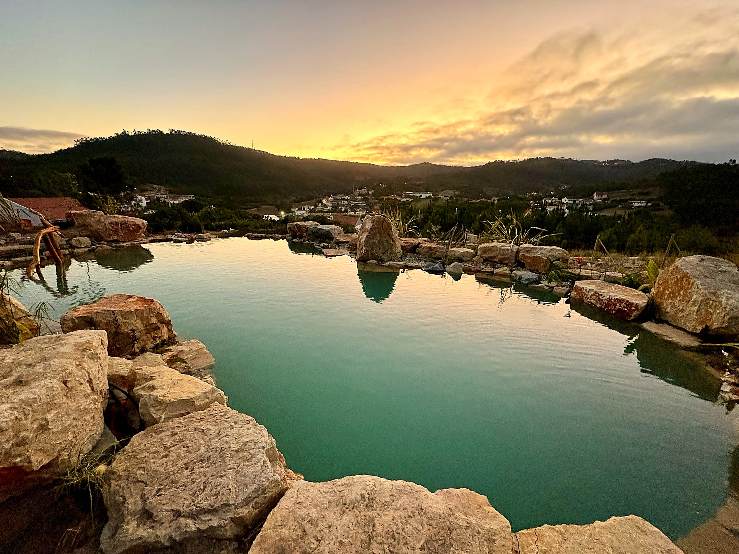 Lisbon Natural Pool Oasis at sunset, stone-edged pool overlooking the valley below